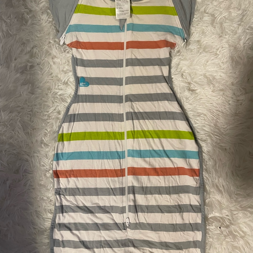 Love to Dream swaddle in Gray, Green, Orange, and White